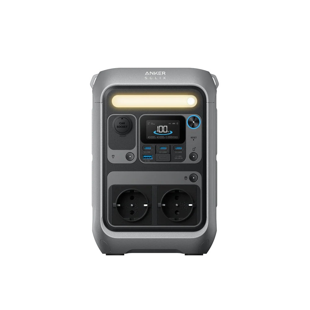 The Anker C300 DC placed next to a laptop to highlight its 30% smaller footprint.