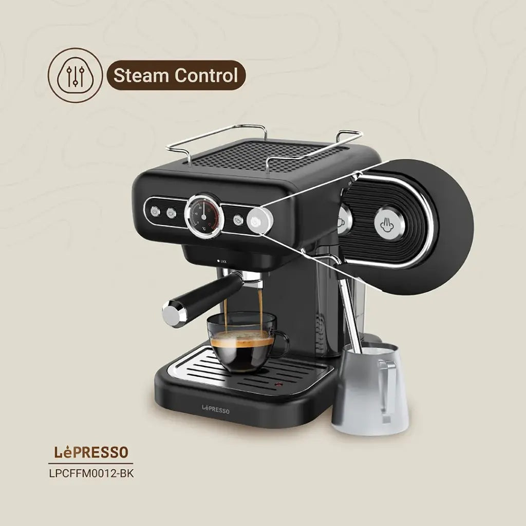 Compact vintage-style espresso machine with drip tray and filters.