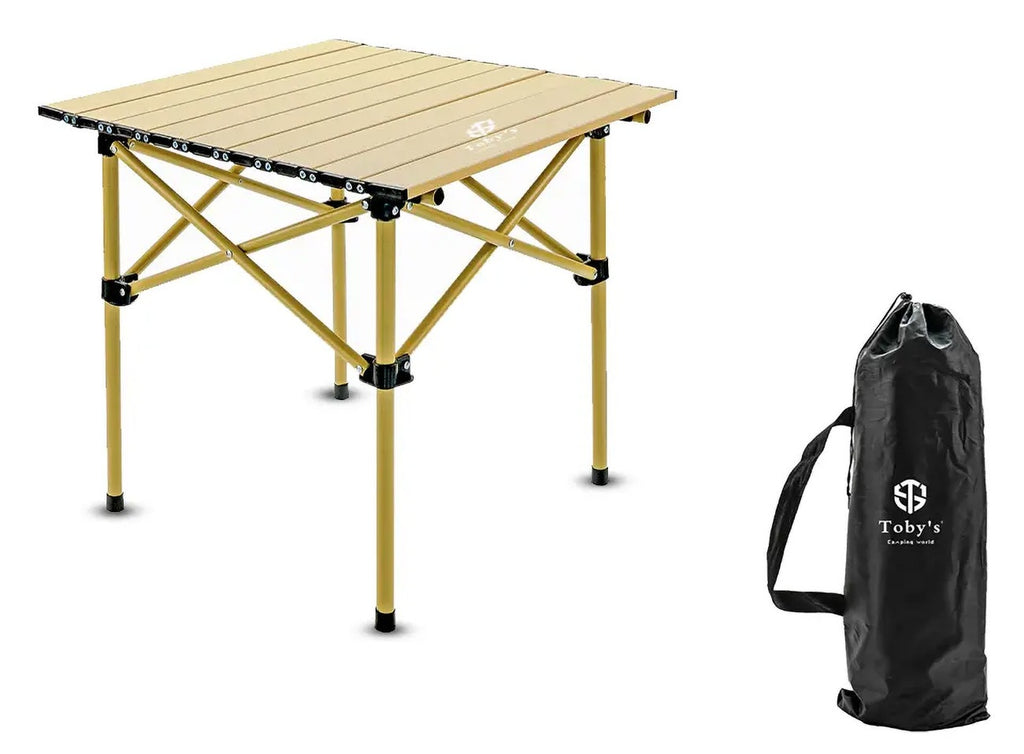Toby's Portable Camping Table – 13, set up outdoors on grass with camping gear.